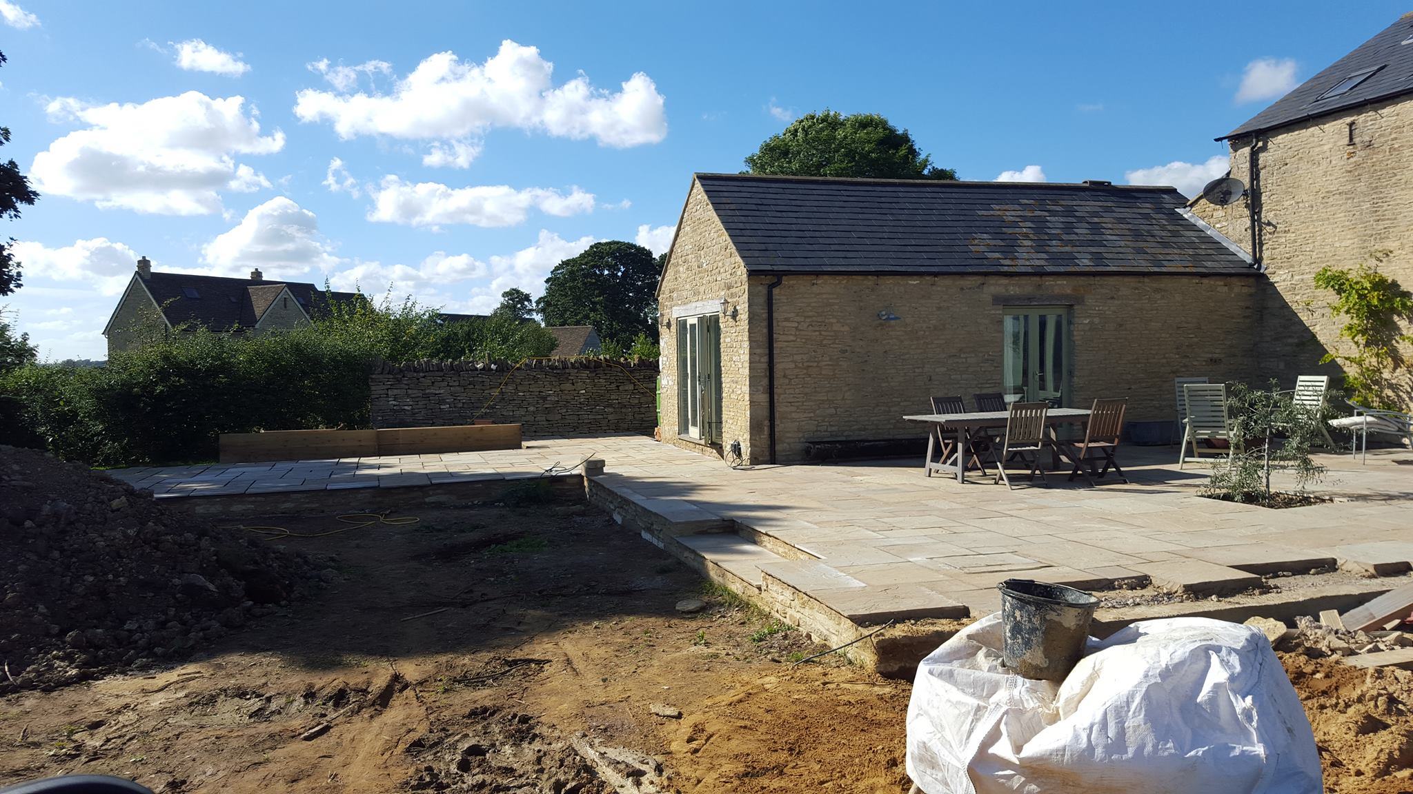 A large sandstone patio area in Duns Tew 6