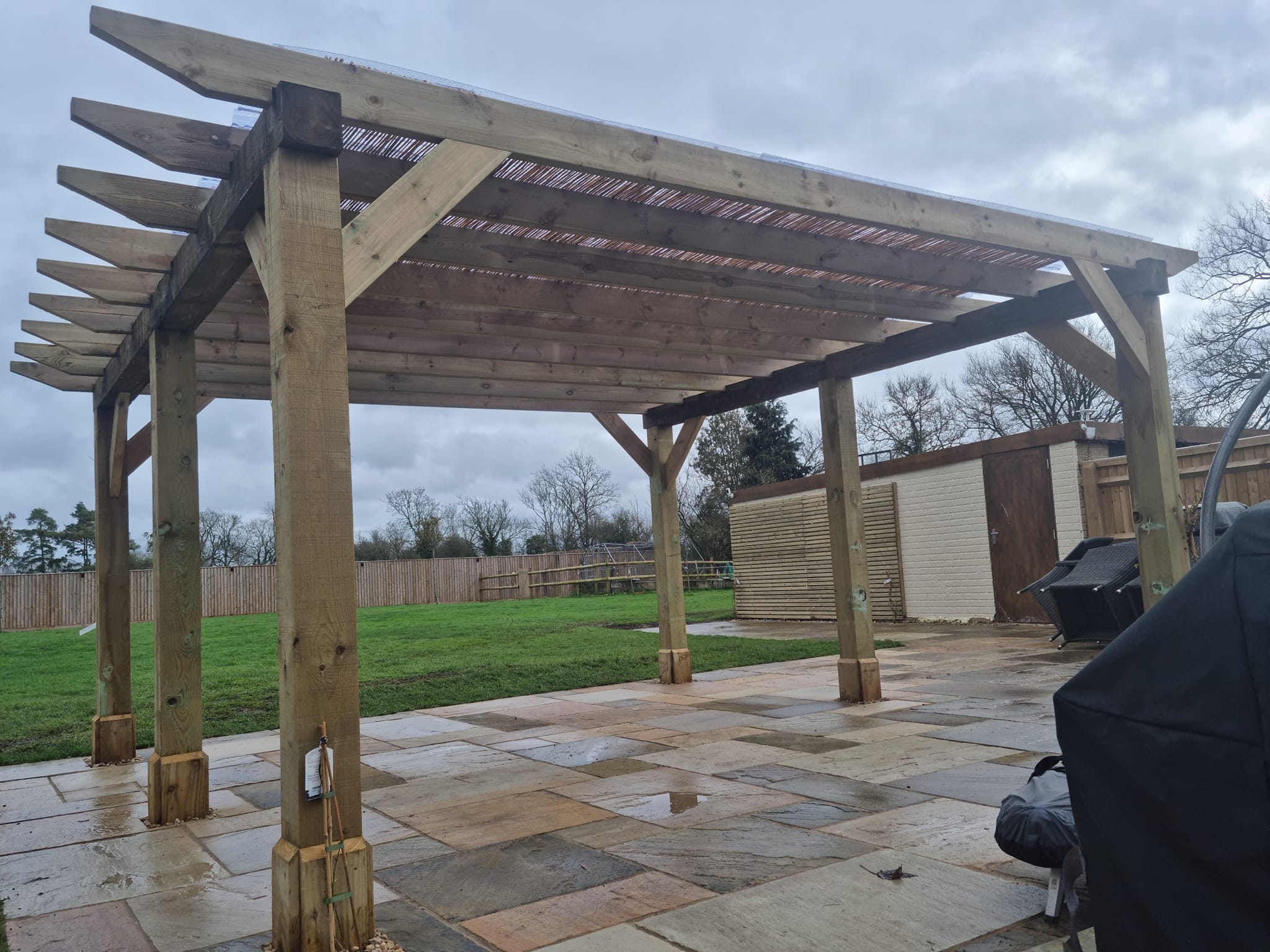 Patio area using both reclaimed and new sandstone pavers with a pergola covered seating area. Completed recently in Murcott
